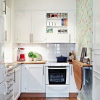 Folding table on the wall of a narrow kitchen