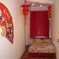 Red curtains on a small bedroom window