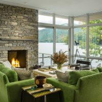 Green sofas in the panoramic glazed room