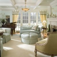 grand piano in a living room with two windows