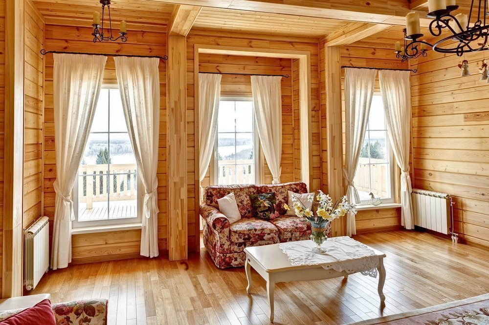 Three windows in the living room of a wooden house