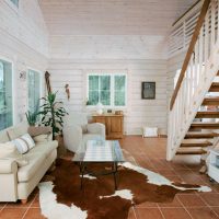 Living room of a country house with a wooden staircase