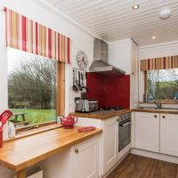 Red striped curtains on the kitchen window.