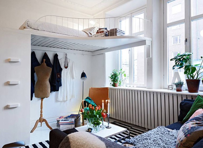 Bed under the ceiling in the interior of a white living room