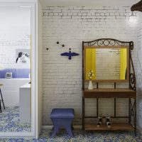 A small table with a mirror in the hallway of a small apartment