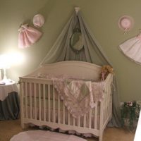 Children's clothing on the wall of the room for the baby