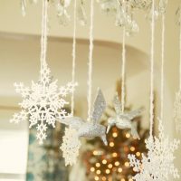 Christmas decorations hanging on a chandelier