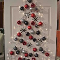 Christmas tree made of colorful balloons on a white door