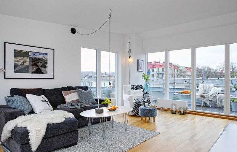 Interior of a white living room without curtains on the windows