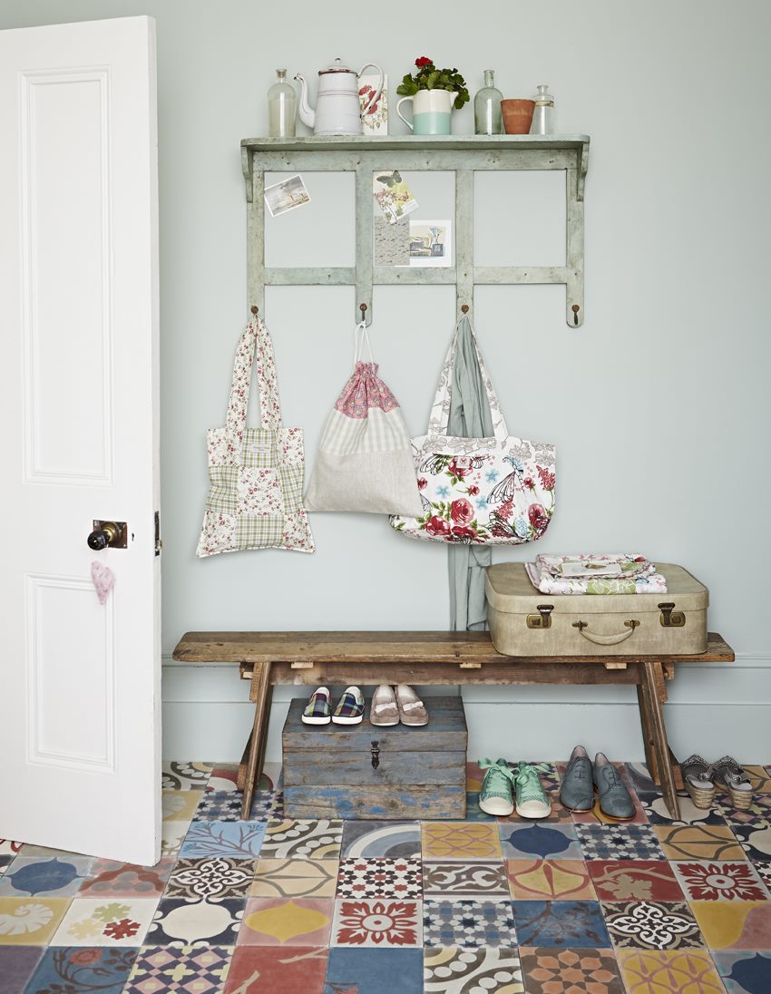 Motley ornamental tiles on the floor of a narrow hallway