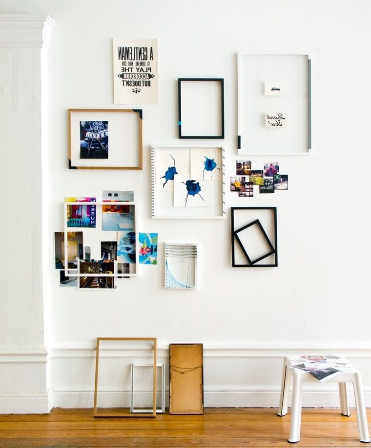 Decorating a white wall with frames and photographs