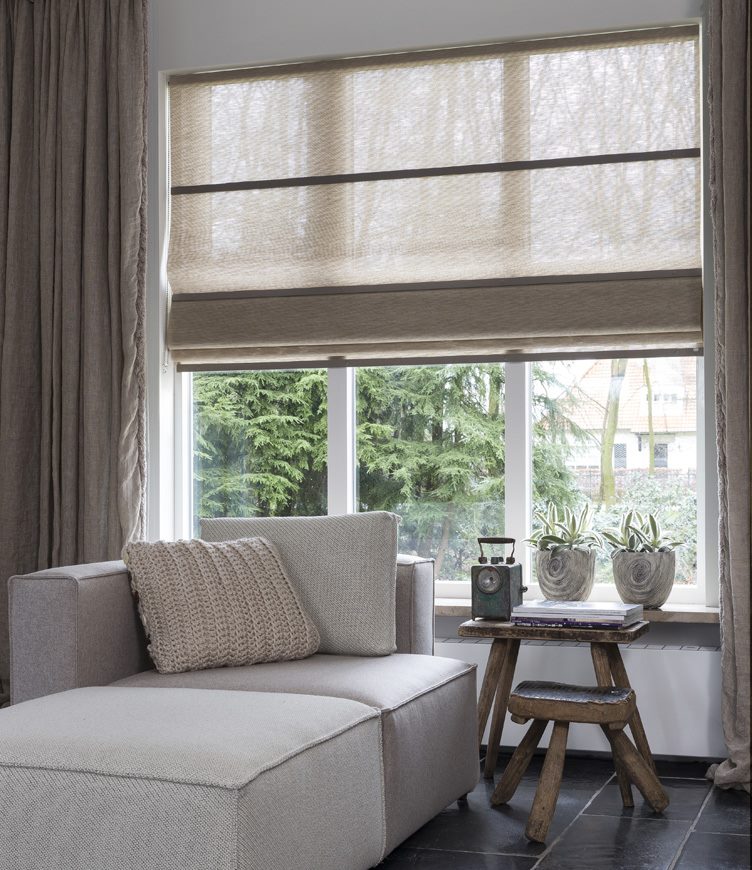 Living room window with different gray curtains