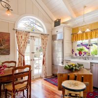 Yellow curtains in the interior of the kitchen-living room