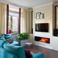 The interior of a small room with a decorative fireplace