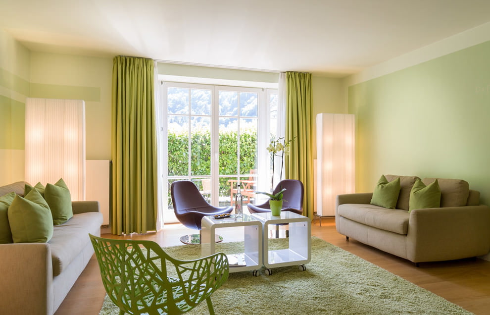 Pale green walls in the living room with two sofas