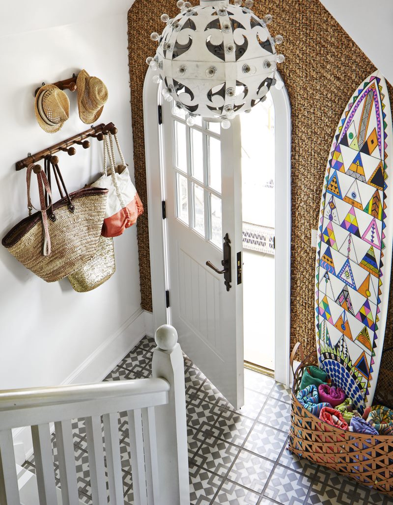 White entrance door in the hallway with stairs.