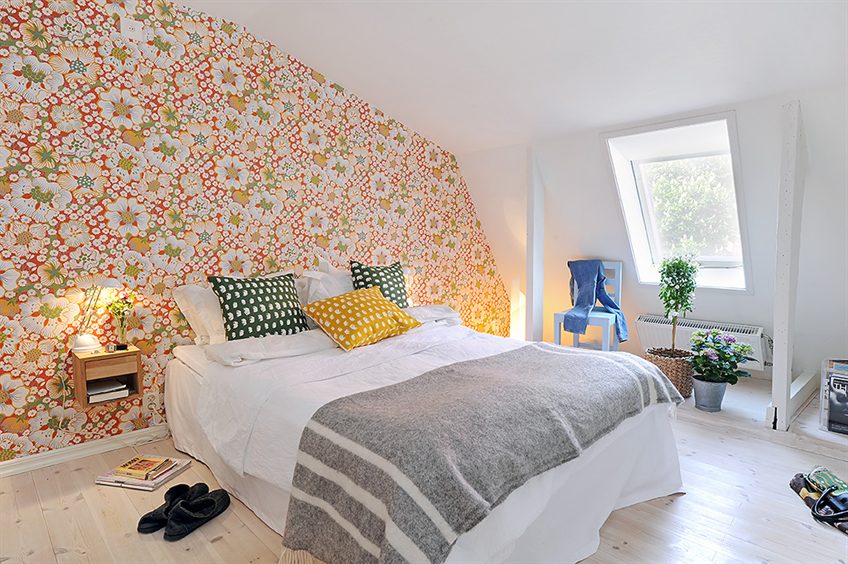 Colorful wallpaper on the wall of the attic bedroom