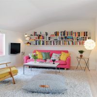 Variegated pillows on a pink sofa