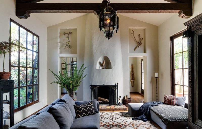 Wooden beam in a living room with two windows