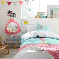 Garland of triangular flags over daughter's bed