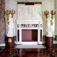 Statues near the fireplace in the antique style living room