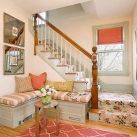 Sofa in front of a staircase in a rural house