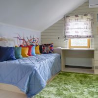 Multi-colored pillows on a narrow bed