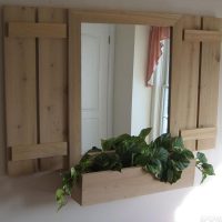 Mirror with shutters on the wall of the hallway