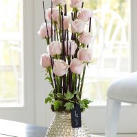 Blijedo ružičasti cvjetovi u metalnoj vazi
