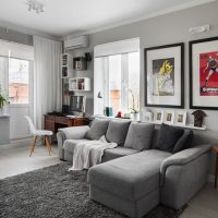 Gray sofa in the interior of the corner living room