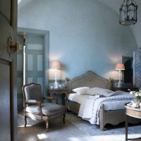 Concrete floor in bedroom with blue walls