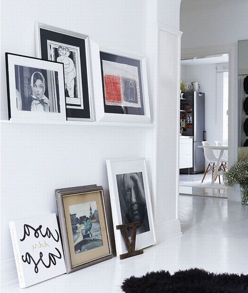 Framed photos on the floor of the living room