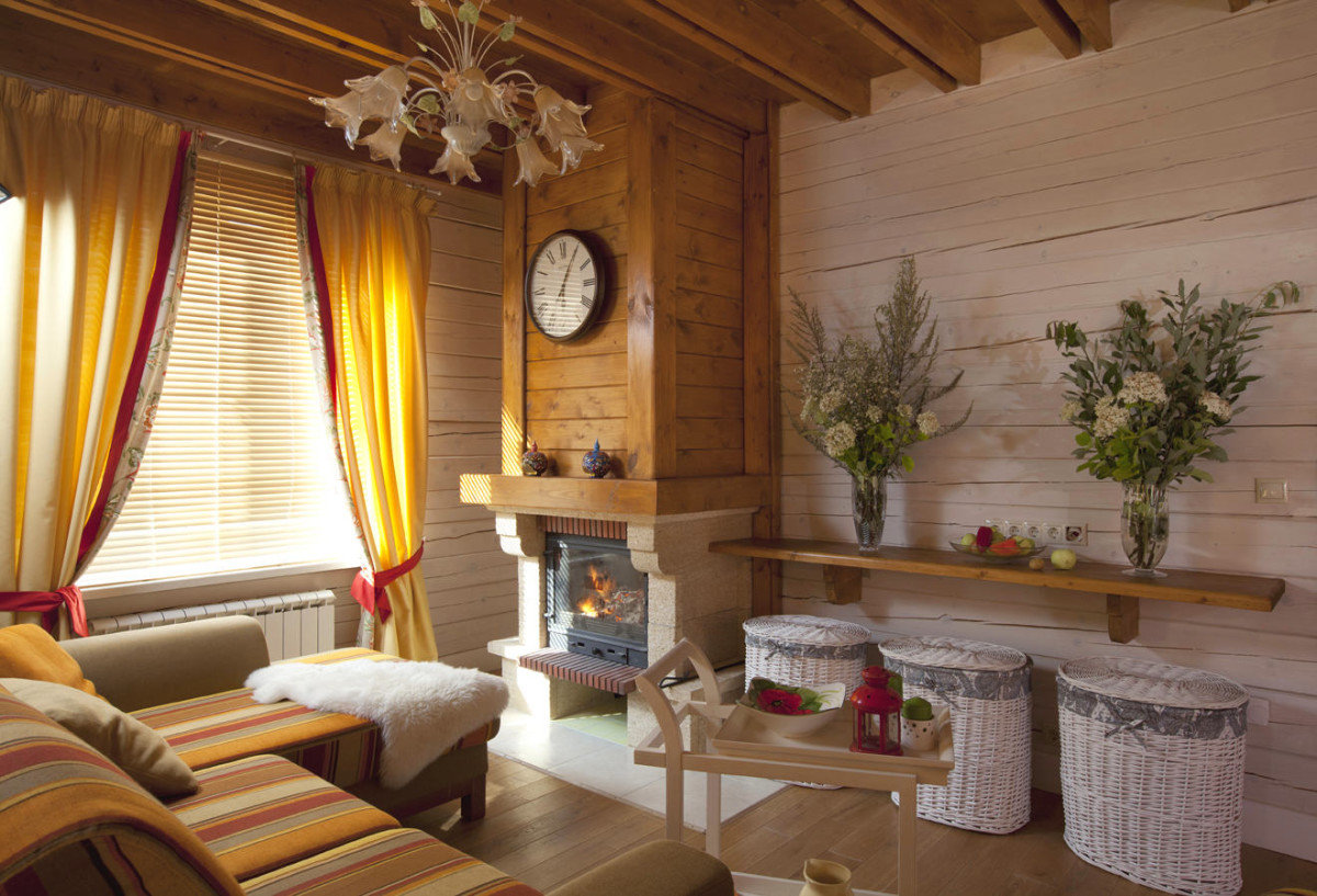 Clock on a wooden paneling of a fireplace in a private house