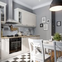 Black and white checkered kitchen floor with gray walls.