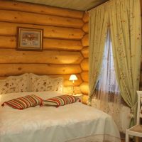 Striped pillows on the bed in the bedroom of a country house