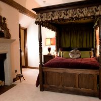 Firewood in a fireplace in a bedroom