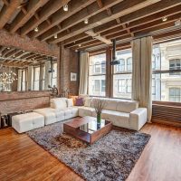 Carpet in the living room with a brick wall