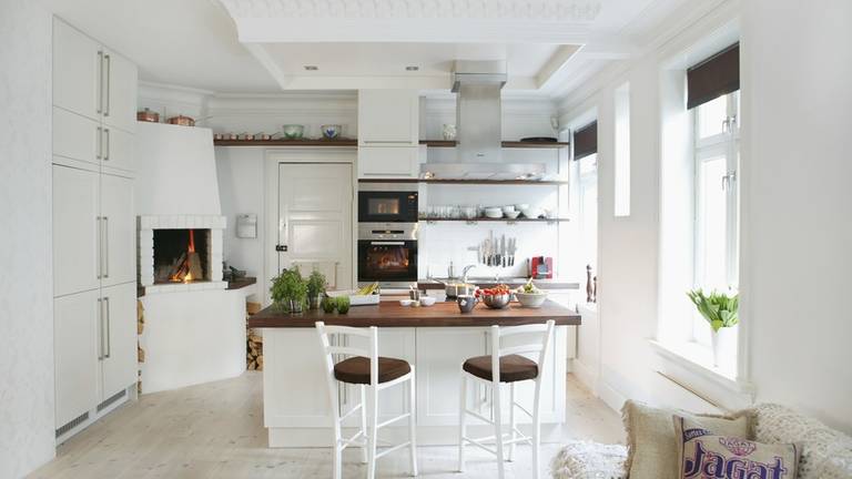 White kitchen interior with fireplace