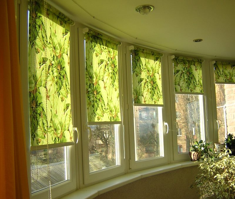 Green curtains on the windows of a semicircular balcony