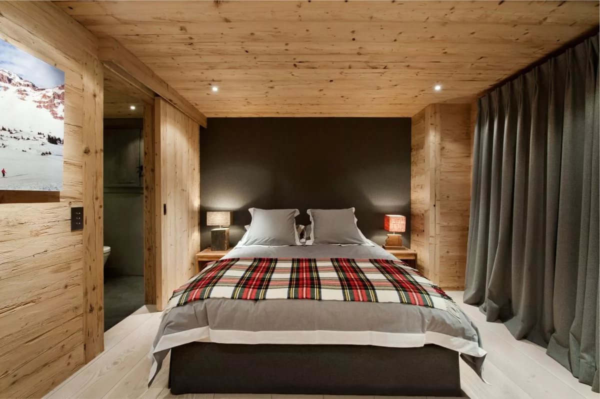 Dark curtains in the bedroom interior of the log house