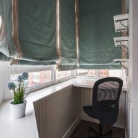 Roman curtains on the windows of a small balcony