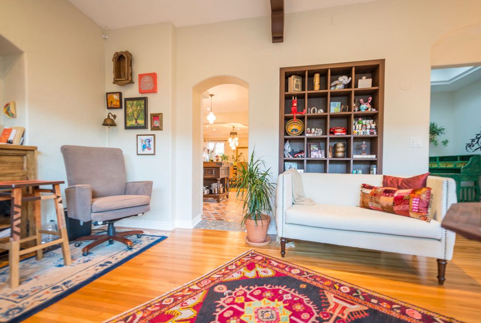 Colorful carpet on the wooden floor of a Spanish-style living room