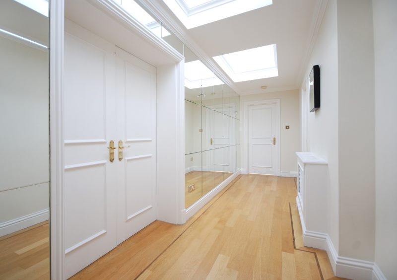 Narrow hallway interior with mirror wall