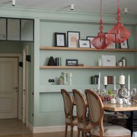 Wooden shelves with photos in a niche