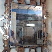 Ammeter on a wooden mirror frame