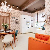 Orange armchair and red sofa in the kitchen-living room