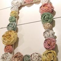 Paper flowers on a photo frame from a tree