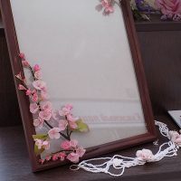 Artificial flowers on a wooden frame