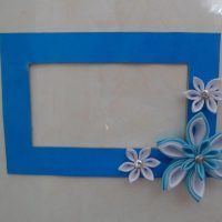 Blue cardboard frame with polymer clay flowers