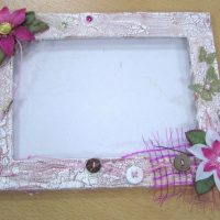 Artificial flowers on an aged wooden frame surface